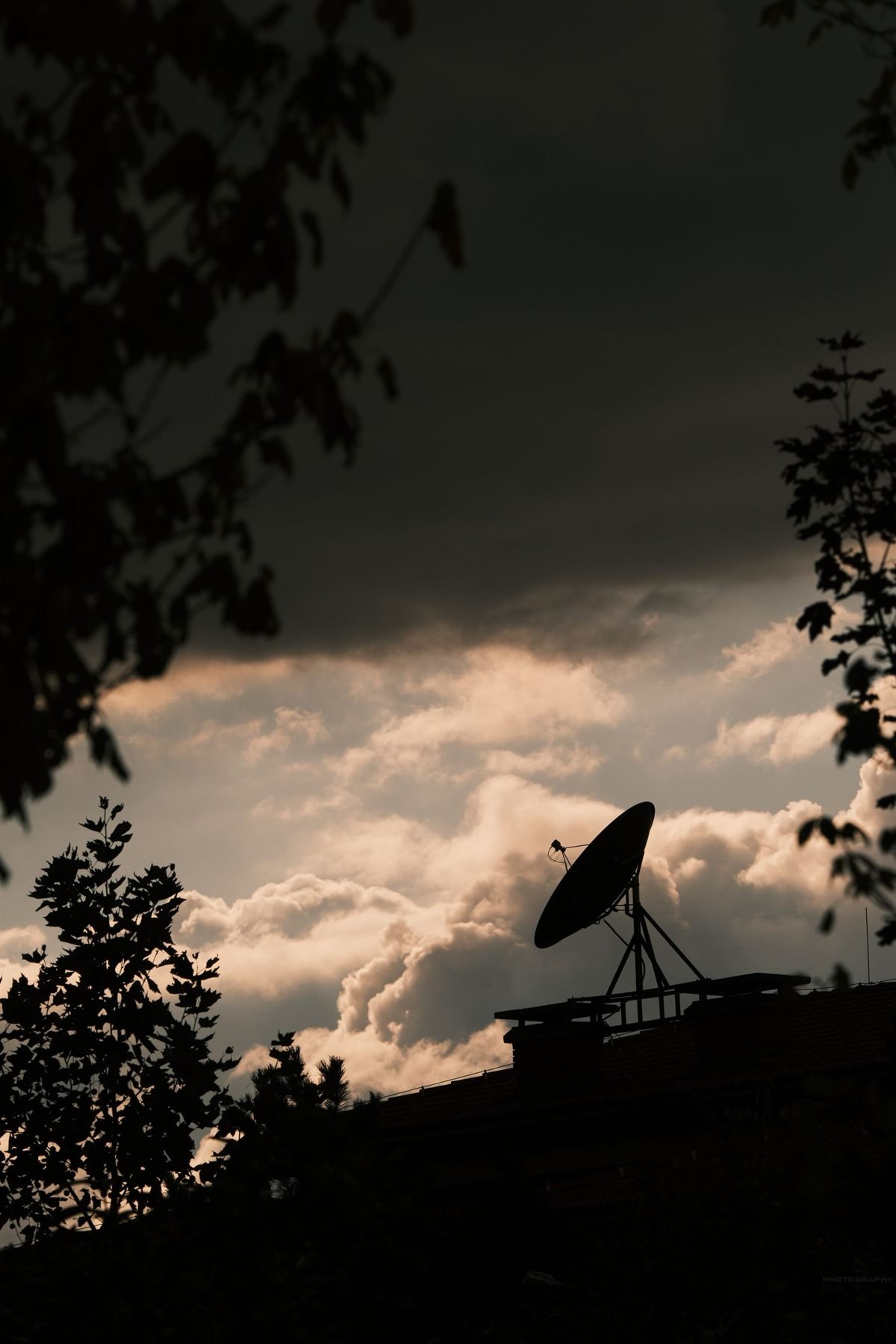 Satellite dish against the sky at dusk