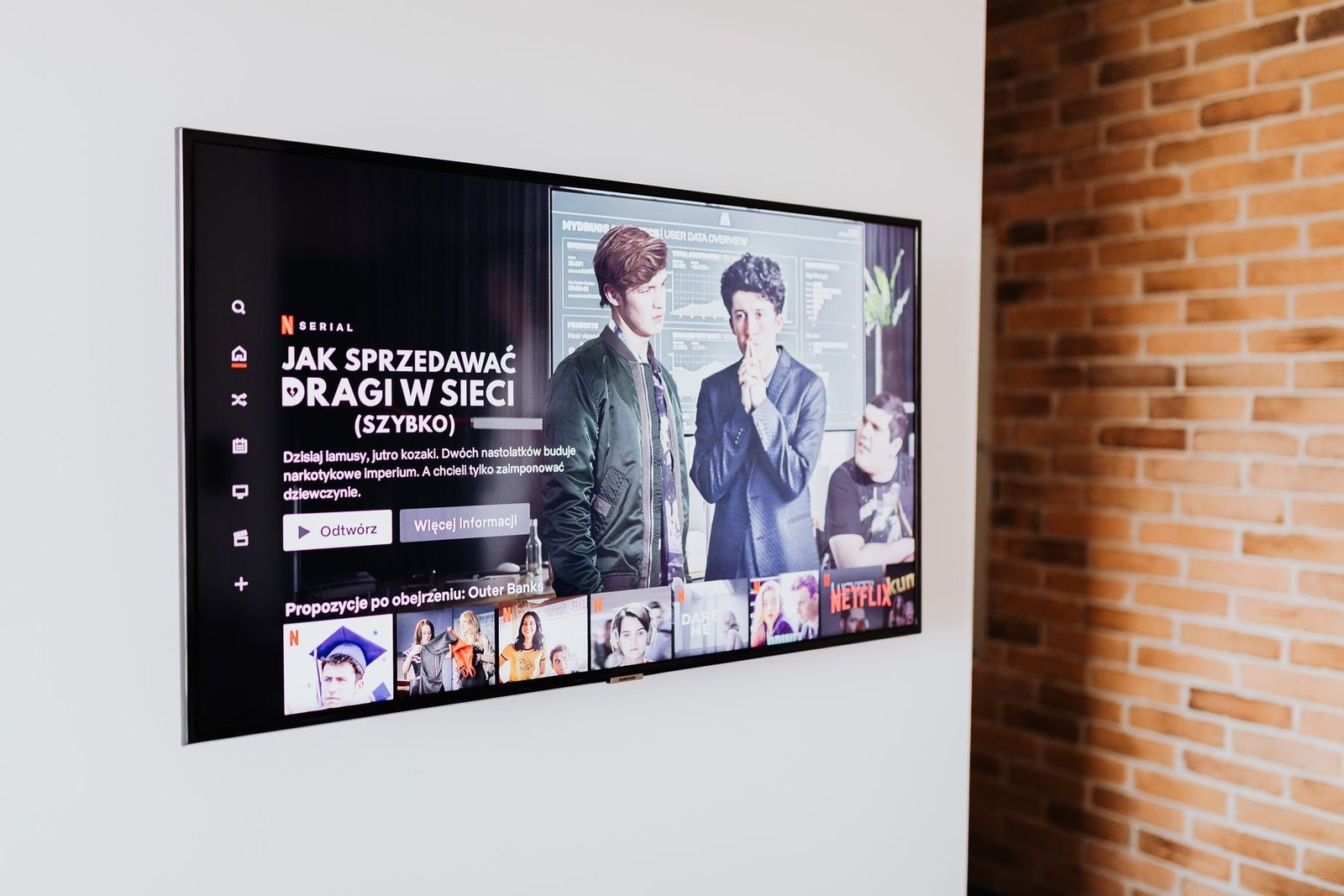 Wall-mounted television showing an on-screen channel menu
