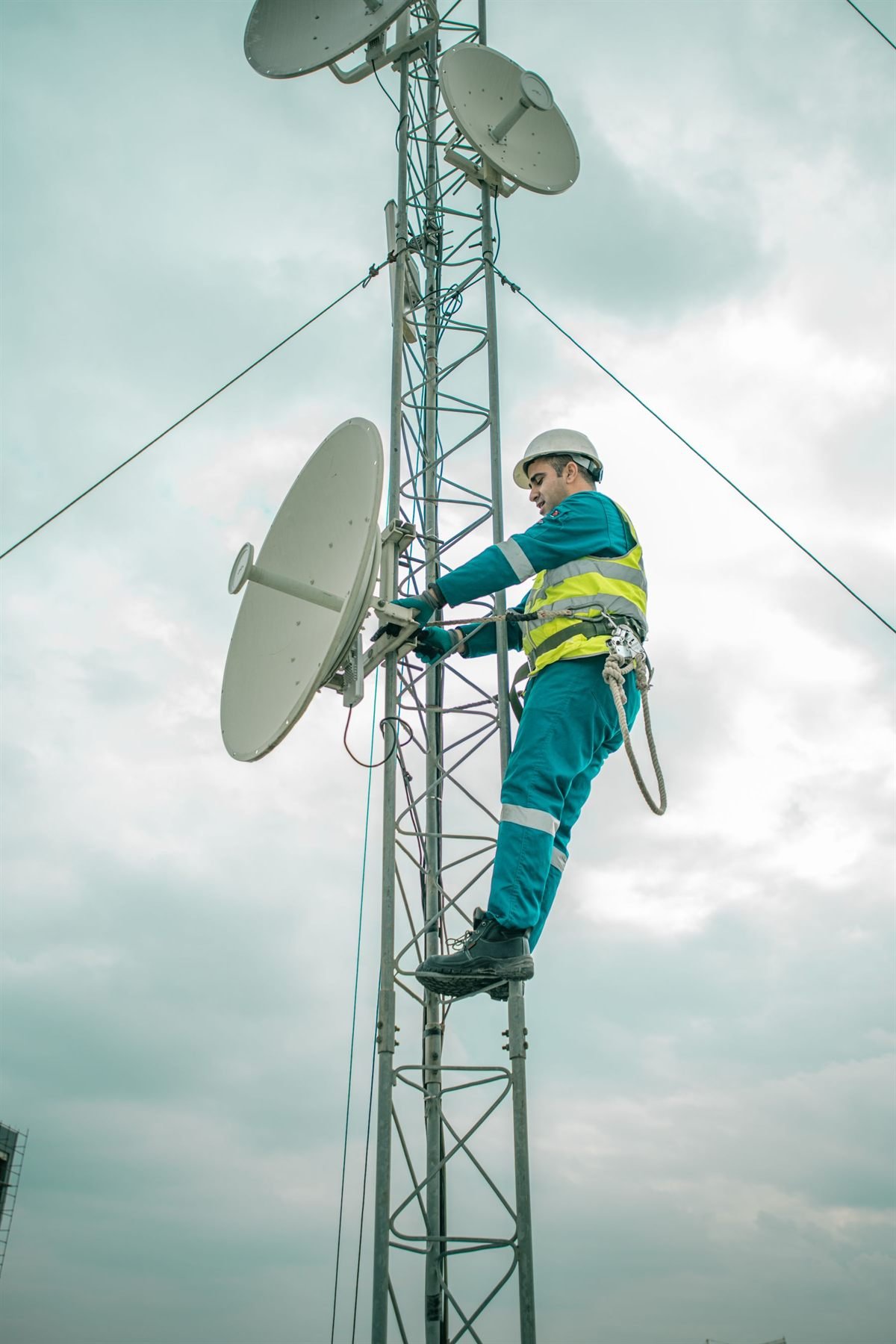 DTH technician working at height on a satellite dish