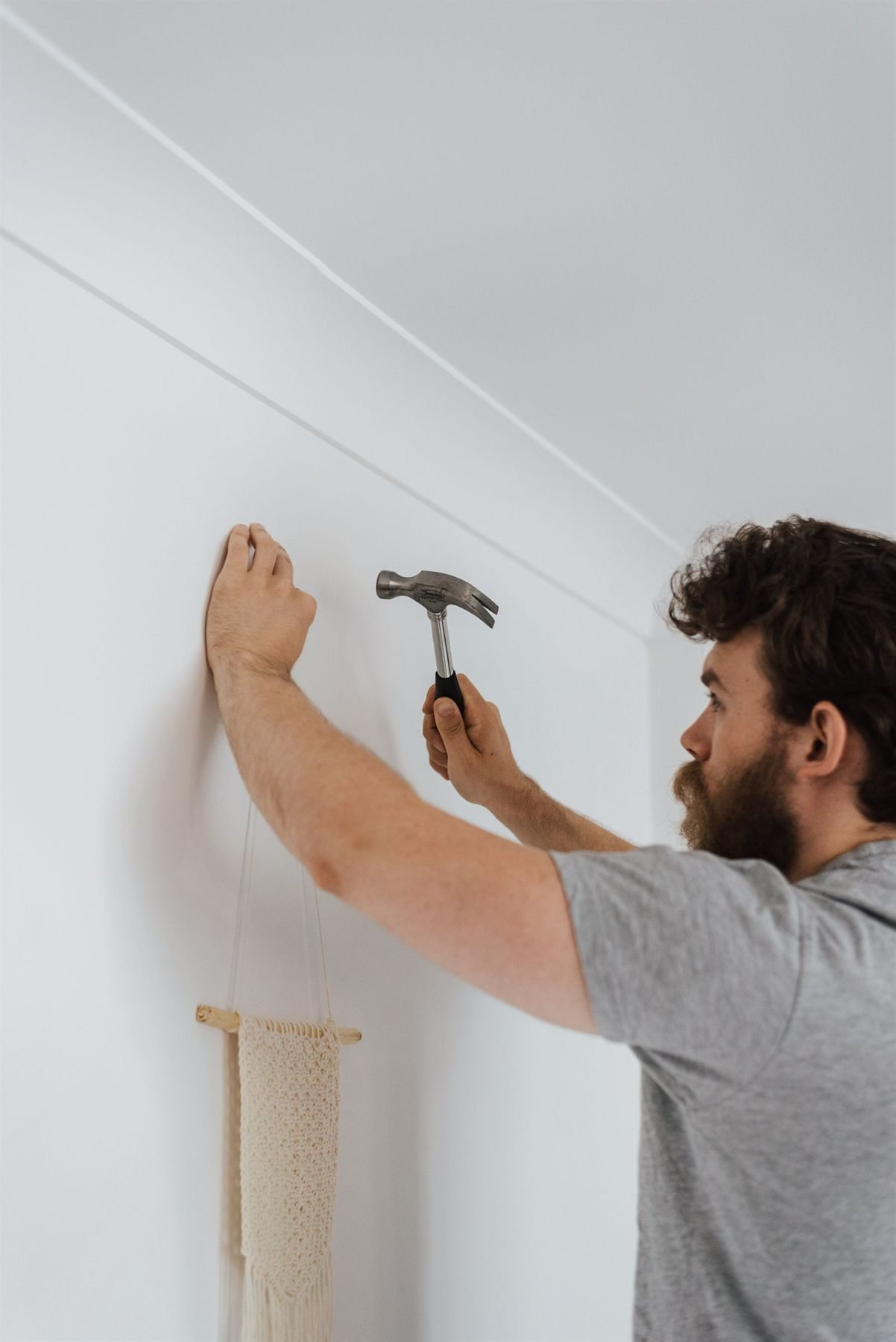 Installer fixing a mounting bracket to a wall